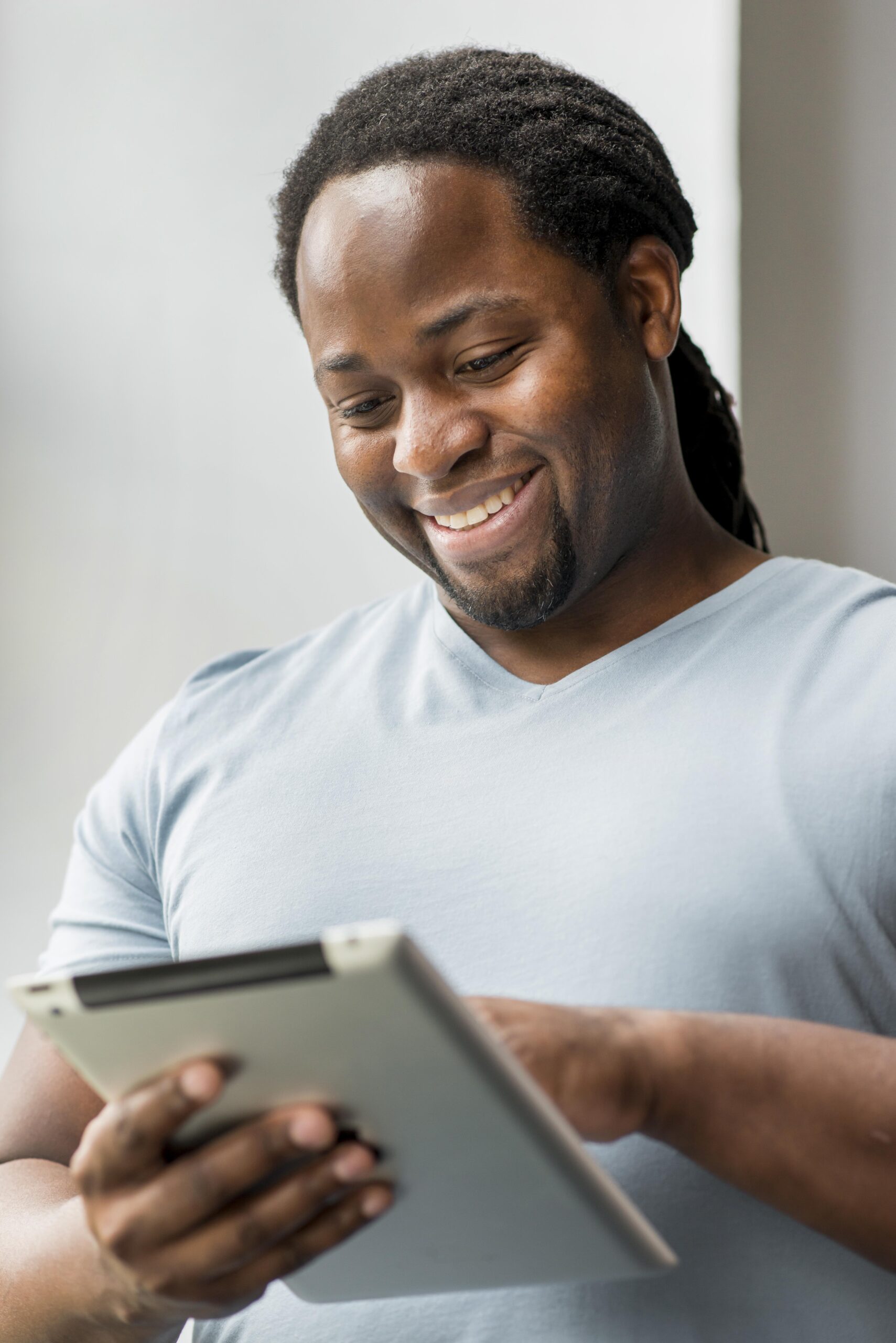 handsome-adult-male-browsing-tablet