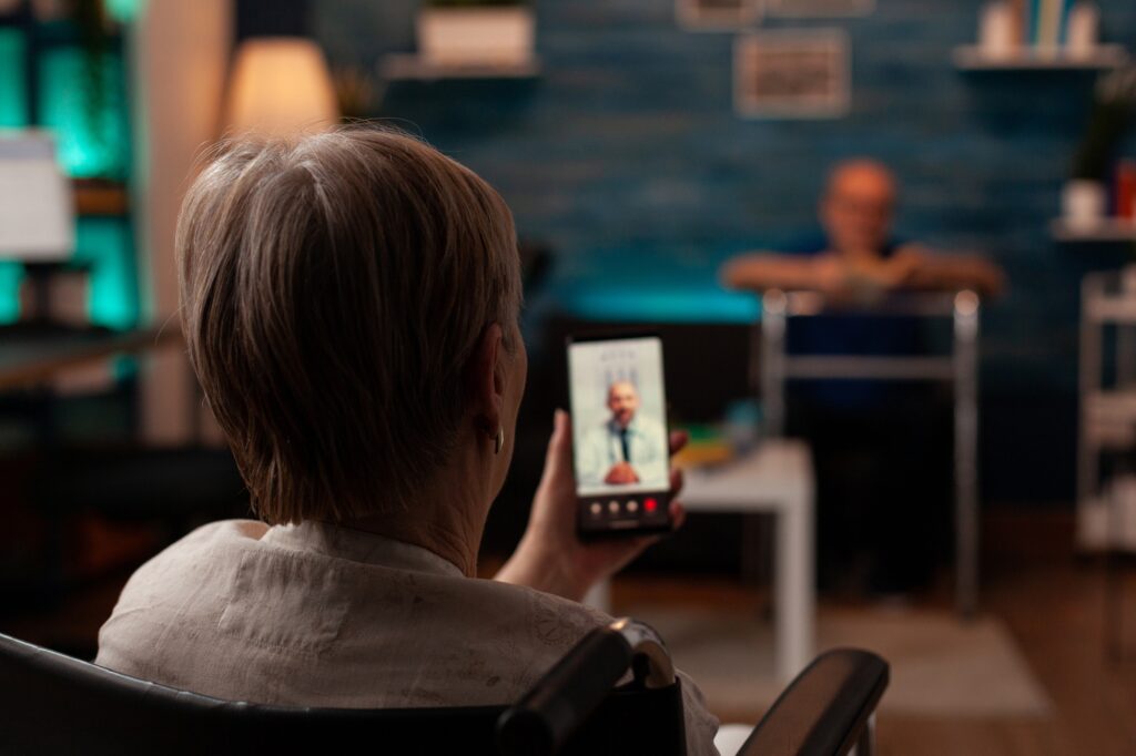 Retired disabled woman talking to doctor on video call